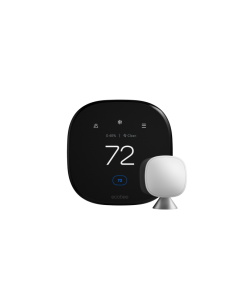 A black square thermostat with rounded edges showing the temperature set to 72. There is a smaller silver device on a stand next to it.